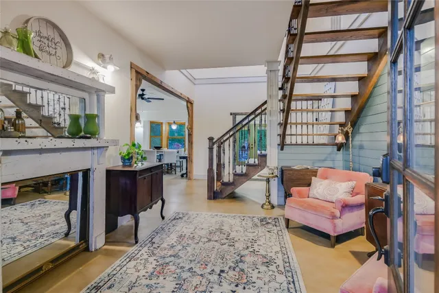 a living room with furniture a rug and a fireplace