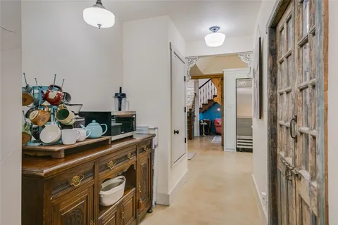 a view of a hallway and a livingroom with furniture