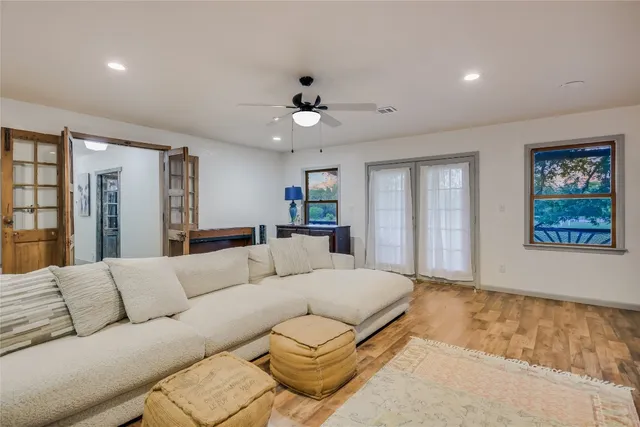 a living room with furniture and a ceiling fan