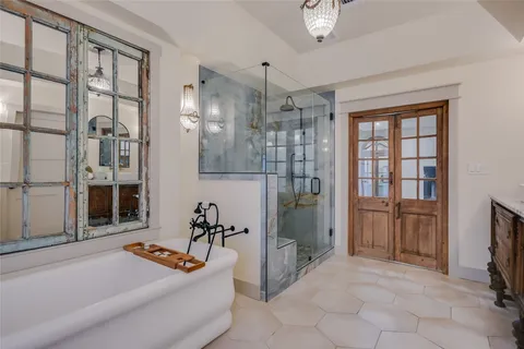 a living room with furniture a flat screen tv and a refrigerator