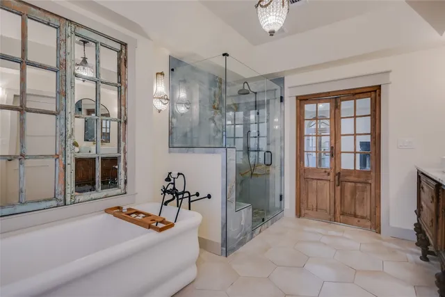 a living room with furniture a flat screen tv and a refrigerator