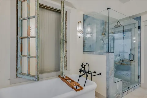 a bathroom with a shower and a glass door