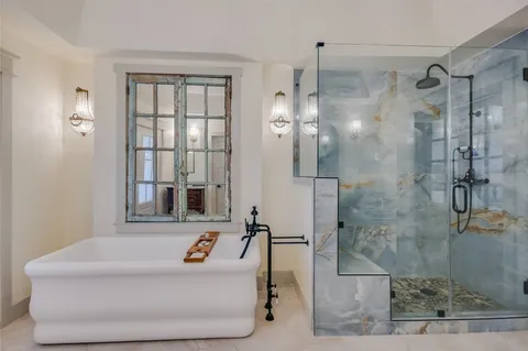 a bathroom with a sink a mirror and shower