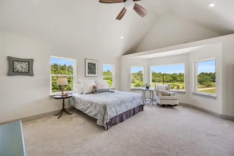 a spacious bedroom with a bed and large window