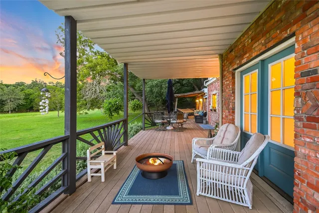 a view of a patio with table and chairs and wooden floor