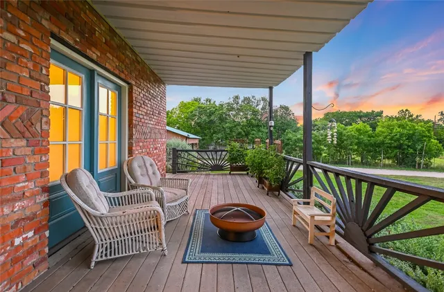 a view of a green field with wooden fence