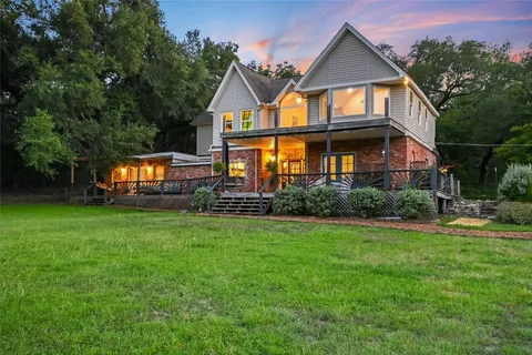 a view of a yard with plants and trees