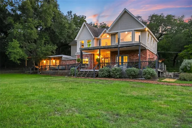 a view of a yard with plants and trees