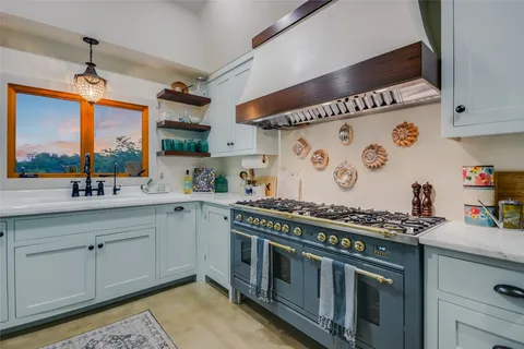 a kitchen that has a stove and a sink