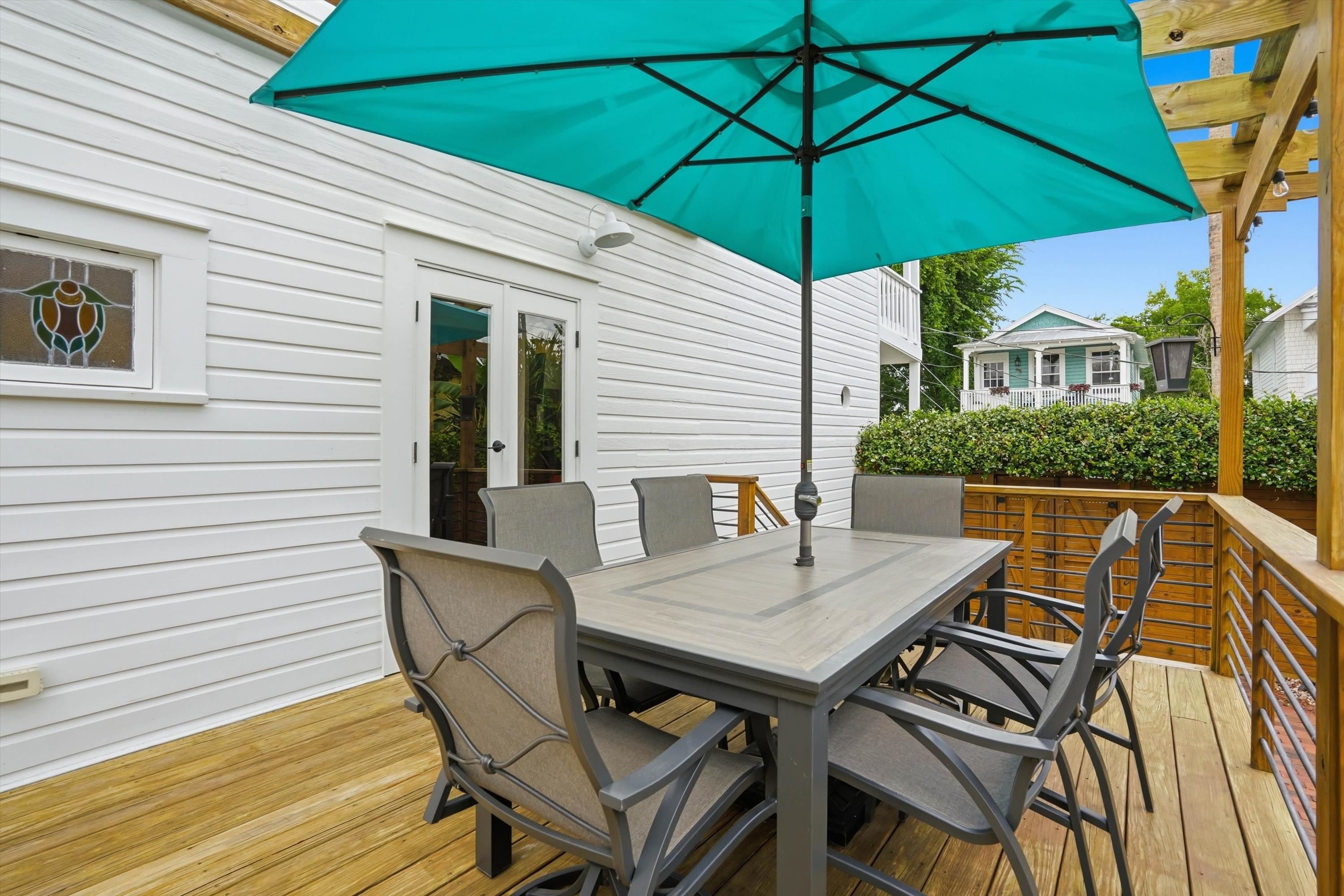 76 Oneida Street St. Augustine, FL 32084 - Photo 31 of 38 a view of a patio with a table and chairs under an umbrella