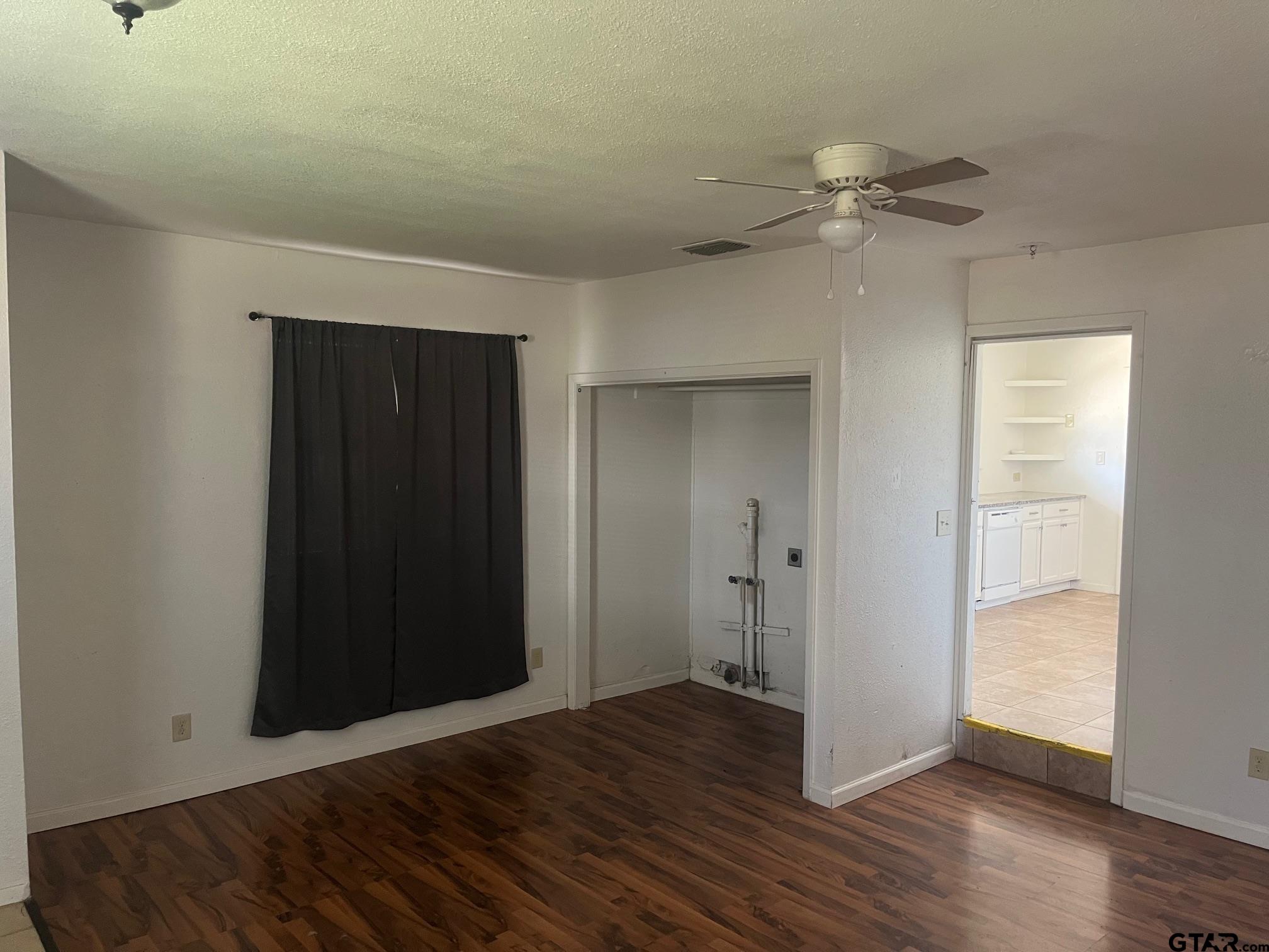 700 West 2nd Street Tyler, TX 75701 - Photo 2 of 10 a view of an empty room with wooden floor