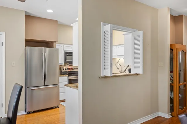 a kitchen with stainless steel appliances a refrigerator and a window