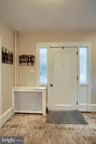 an empty room with wooden floor and cabinet