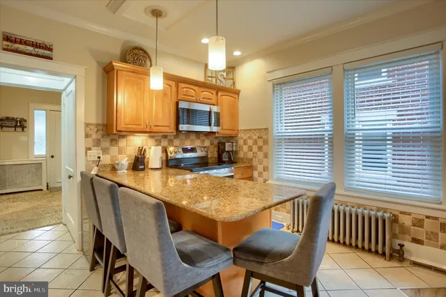 a kitchen with counter top space and living room