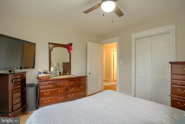 a living room with furniture a ceiling fan and a window