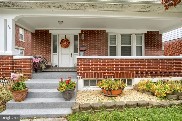a front view of a house with outdoor seating