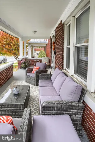 a bedroom with furniture and a large window