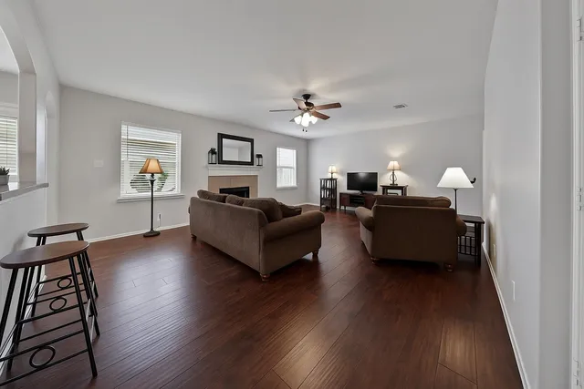 a living room with furniture and a wooden floor