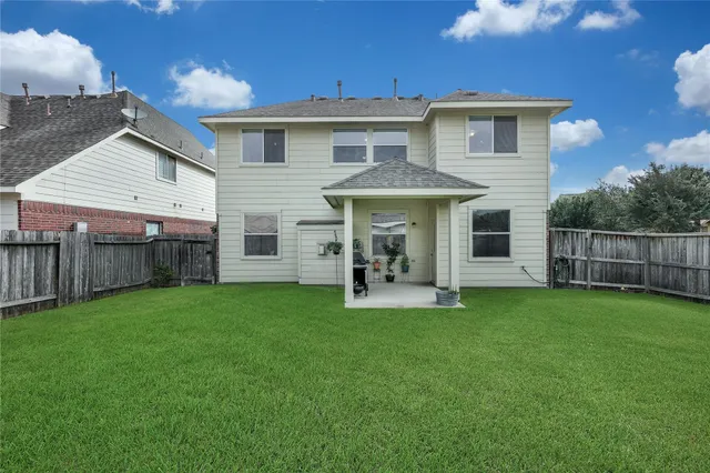 a view of a house with a yard and sitting area