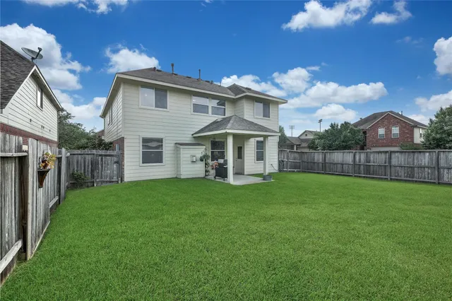 a view of a house with a yard and deck