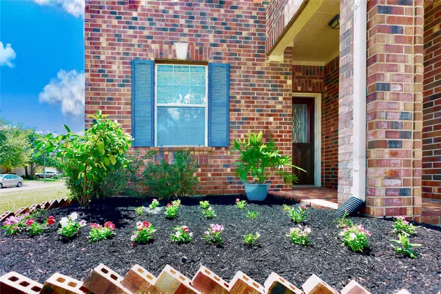 a view of a backyard with a flower garden
