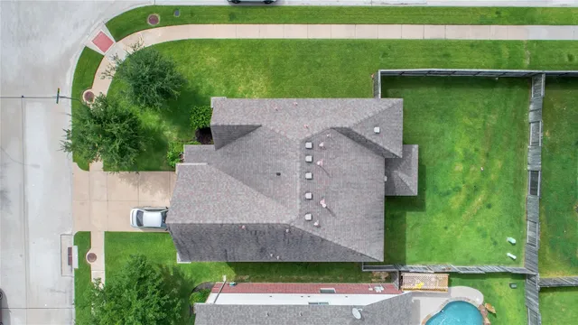 an aerial view of a house with a yard
