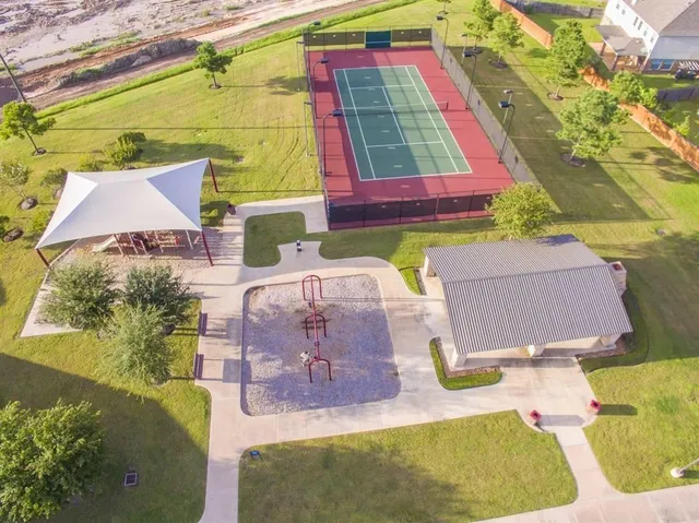an aerial view of residential houses with outdoor space