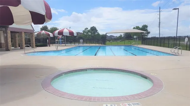a view of a swimming pool with an outdoor seating