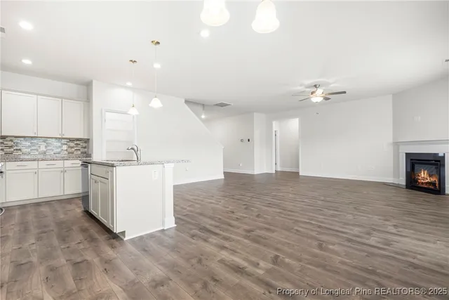 a view of kitchen with cabinets and wooden floor