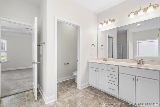 a spacious bathroom with a granite countertop sink mirror and a