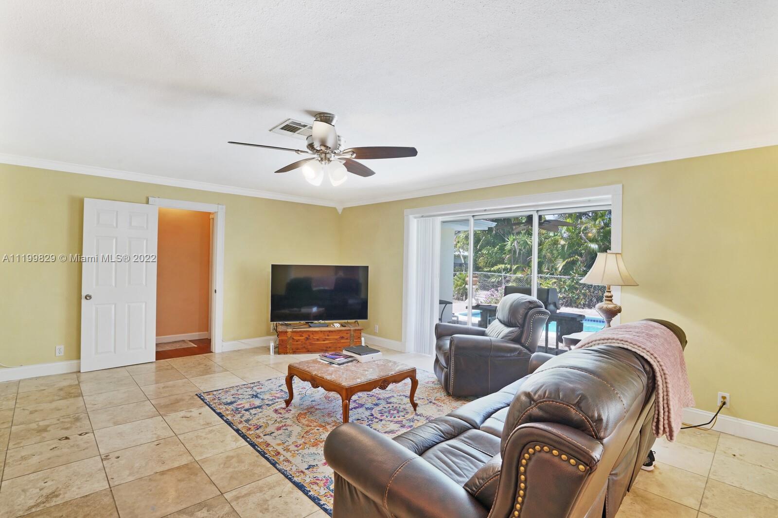 365 Northeast 3rd Street Boca Raton, FL 33432 - Photo 13 of 25 a living room with furniture and a flat screen tv