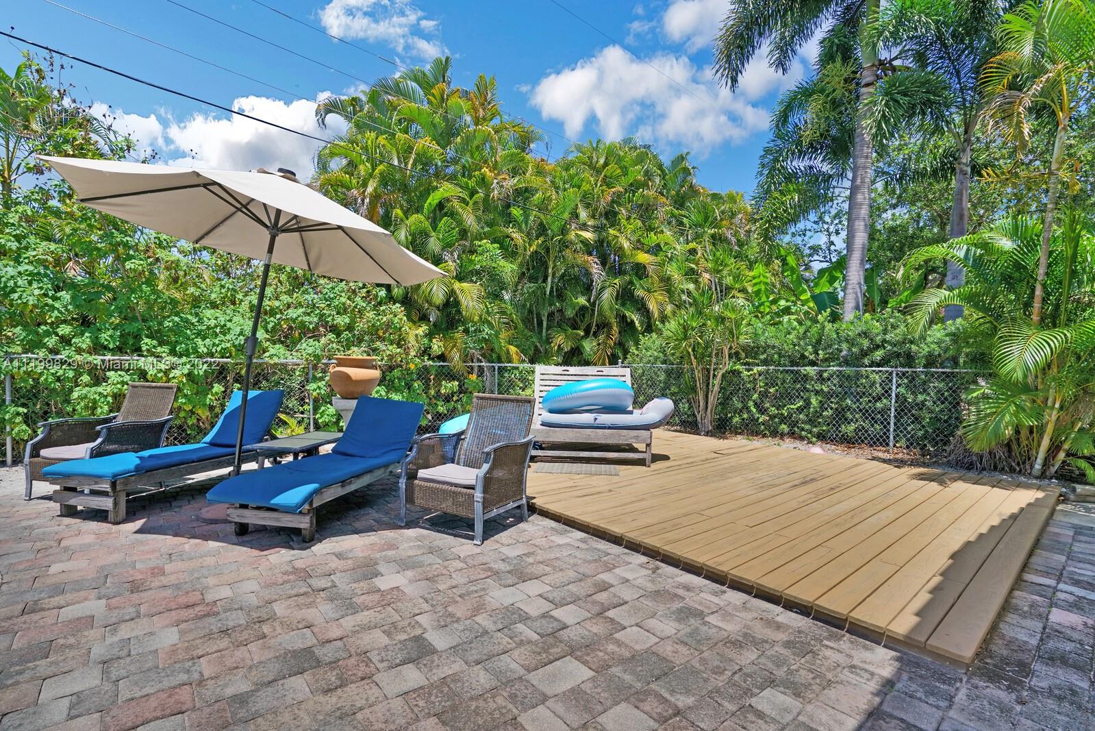 365 Northeast 3rd Street Boca Raton, FL 33432 - Photo 21 of 25 a view of backyard with outdoor seating and trees