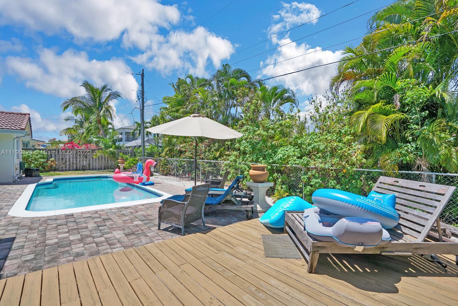 365 Northeast 3rd Street Boca Raton, FL 33432 - Photo 22 of 25 a backyard of a house with table and chairs