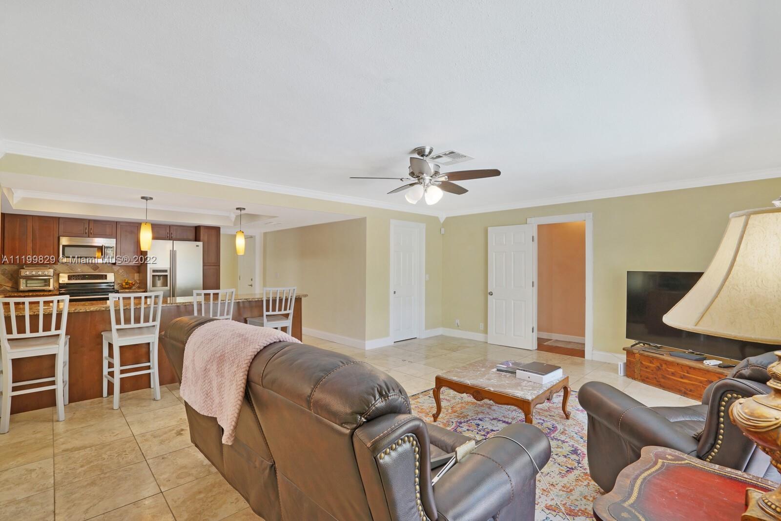 365 Northeast 3rd Street Boca Raton, FL 33432 - Photo 10 of 25 a living room with furniture ceiling fan and a rug