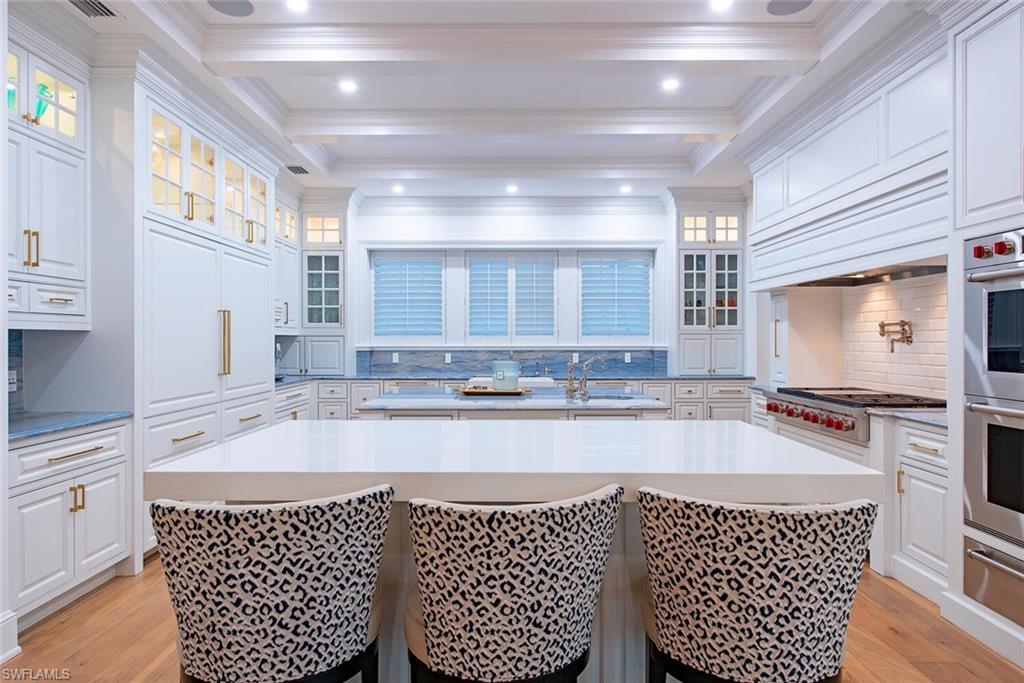 140 3rd Avenue South Naples, FL 34102 - Photo 11 of 46 a large kitchen with granite countertop a sink and cabinets