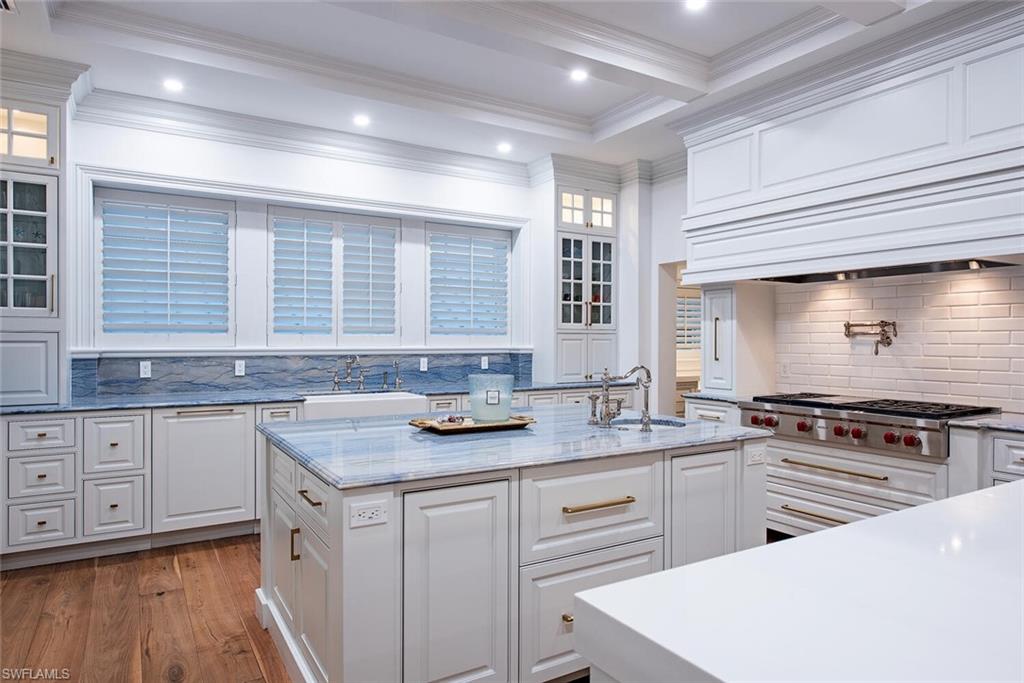 140 3rd Avenue South Naples, FL 34102 - Photo 12 of 46 a kitchen with granite countertop stainless steel appliances white cabinets sink and a granite counter tops