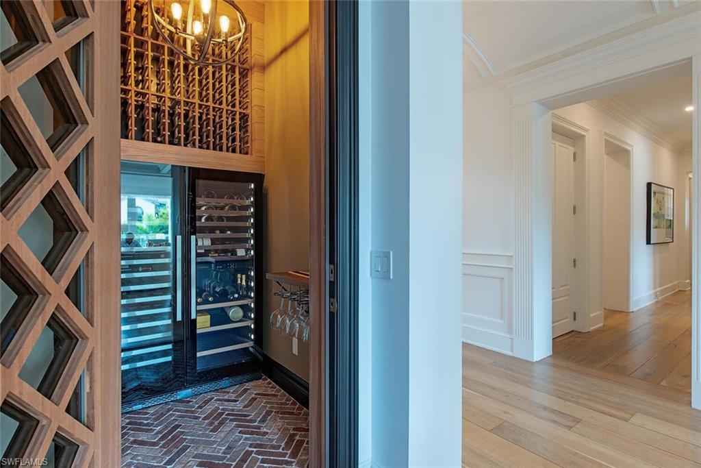 140 3rd Avenue South Naples, FL 34102 - Photo 14 of 46 a view of walk in closet with clothes and shoes