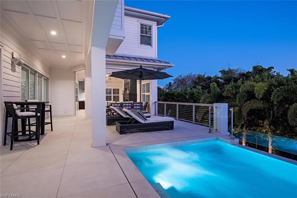140 3rd Avenue South Naples, FL 34102 - Photo 22 of 46 a view of a chairs and tables in the patio
