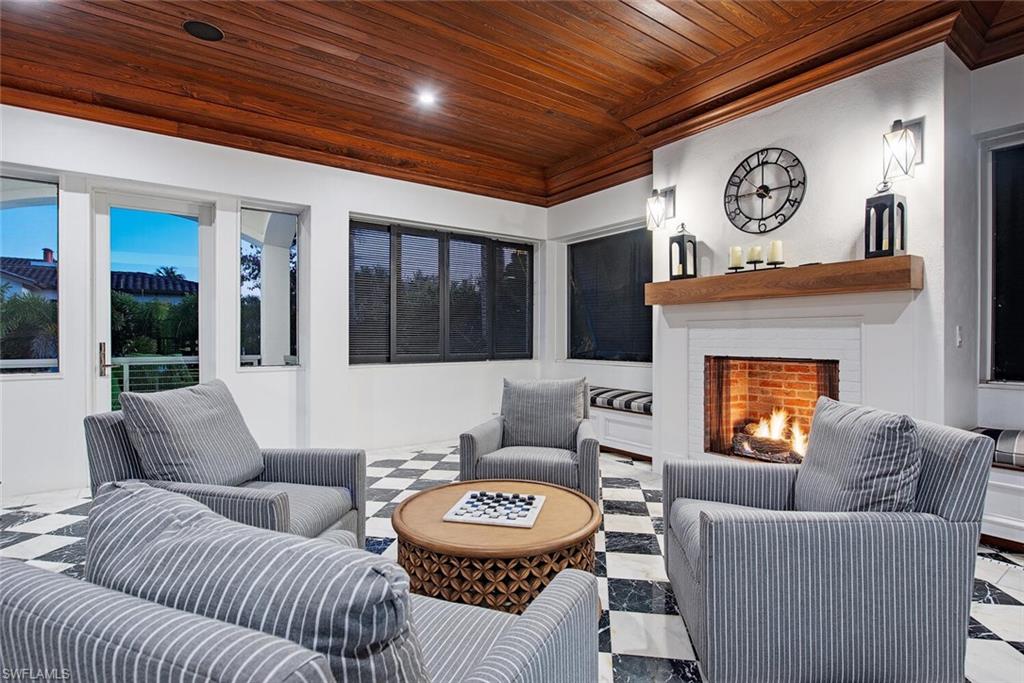 140 3rd Avenue South Naples, FL 34102 - Photo 23 of 46 a living room with furniture and a fireplace
