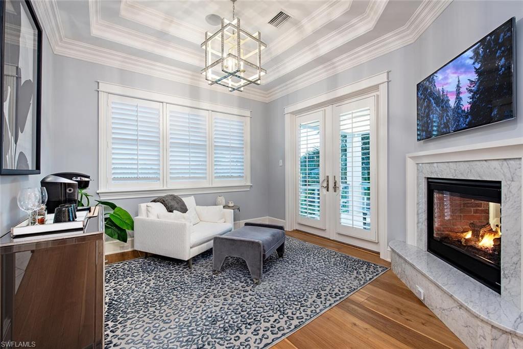 140 3rd Avenue South Naples, FL 34102 - Photo 27 of 46 a living room with furniture and a fireplace