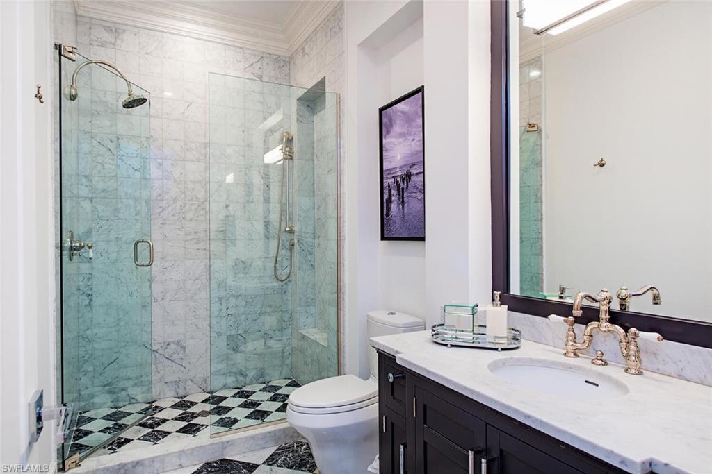 140 3rd Avenue South Naples, FL 34102 - Photo 30 of 46 a bathroom with a sink a toilet and shower