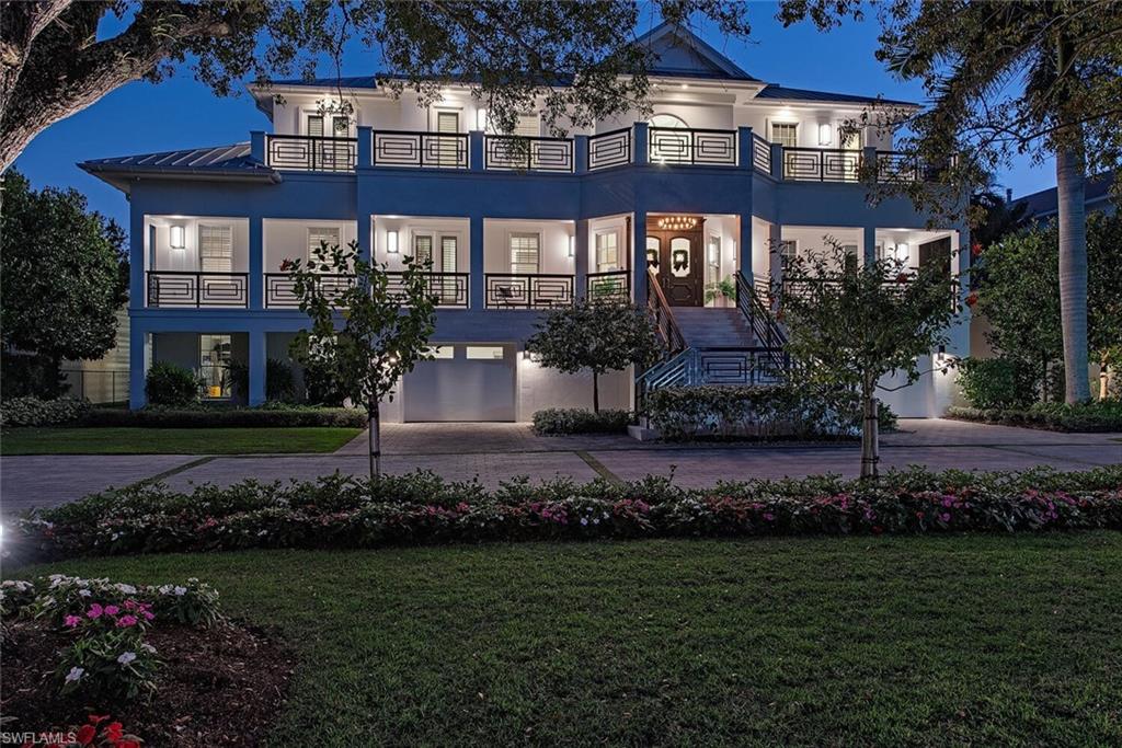 140 3rd Avenue South Naples, FL 34102 - Photo 3 of 46 a front view of a house with a garden