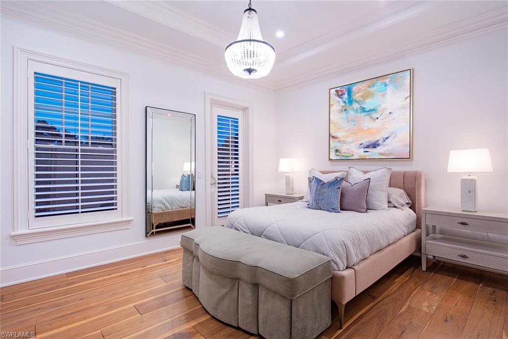 140 3rd Avenue South Naples, FL 34102 - Photo 31 of 46 a bedroom with a large bed couch and window