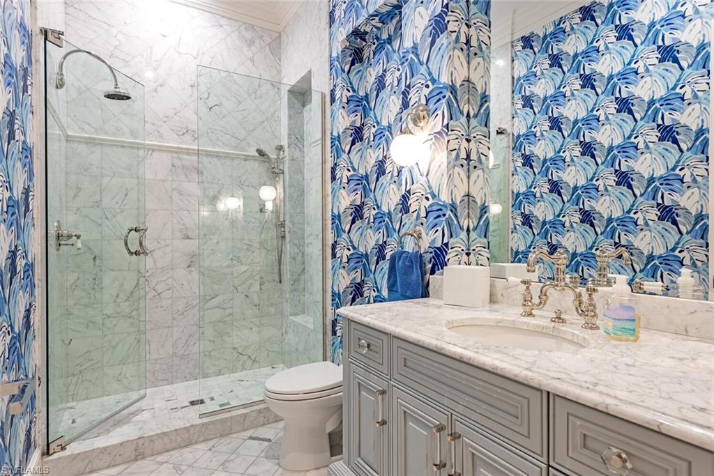 140 3rd Avenue South Naples, FL 34102 - Photo 34 of 46 a bathroom with a granite countertop sink a toilet and shower