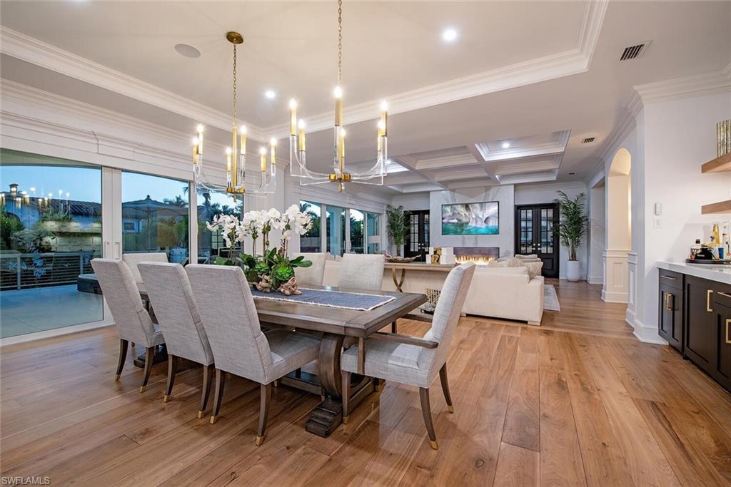 140 3rd Avenue South Naples, FL 34102 - Photo 6 of 46 a view of a dining room with furniture window and wooden floor