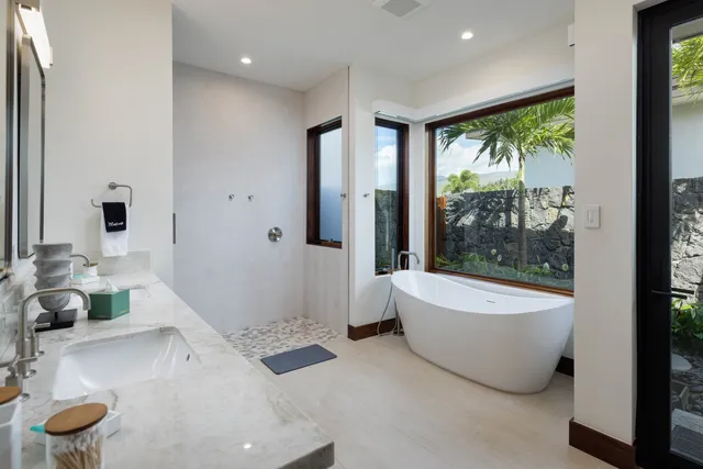 a bathroom with a tub a toilet and a sink