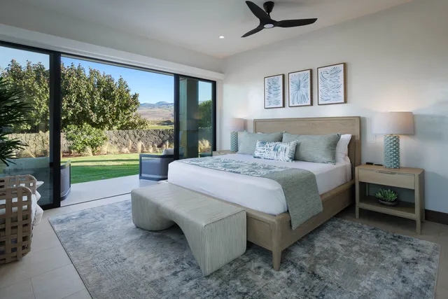 a spacious bedroom with a bed and large trees