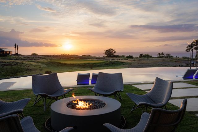 a view of a chairs and table in the ocean