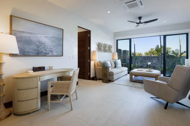 a work room with furniture and a floor to ceiling window
