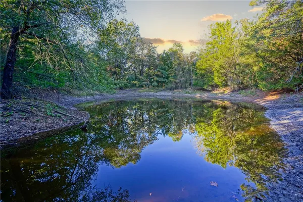 a view of a lake with a house in the background